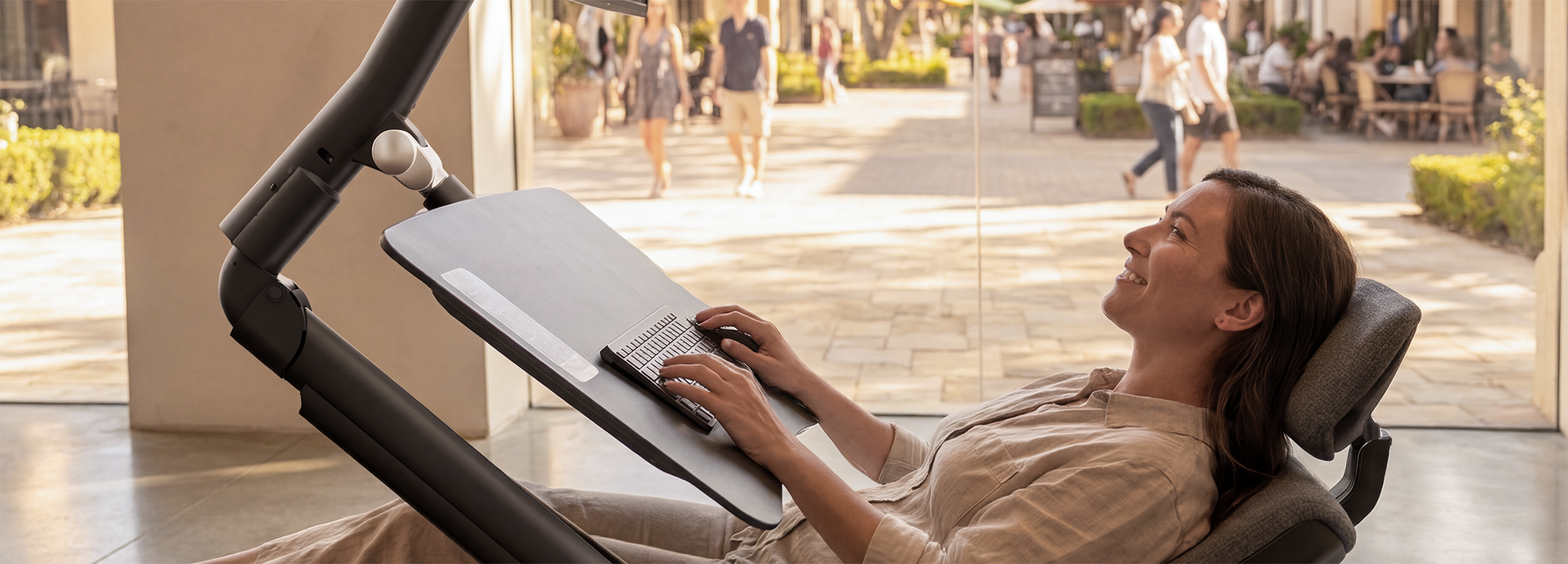 Woman using a Altwork Signature Station in reclinded in a retail store setting